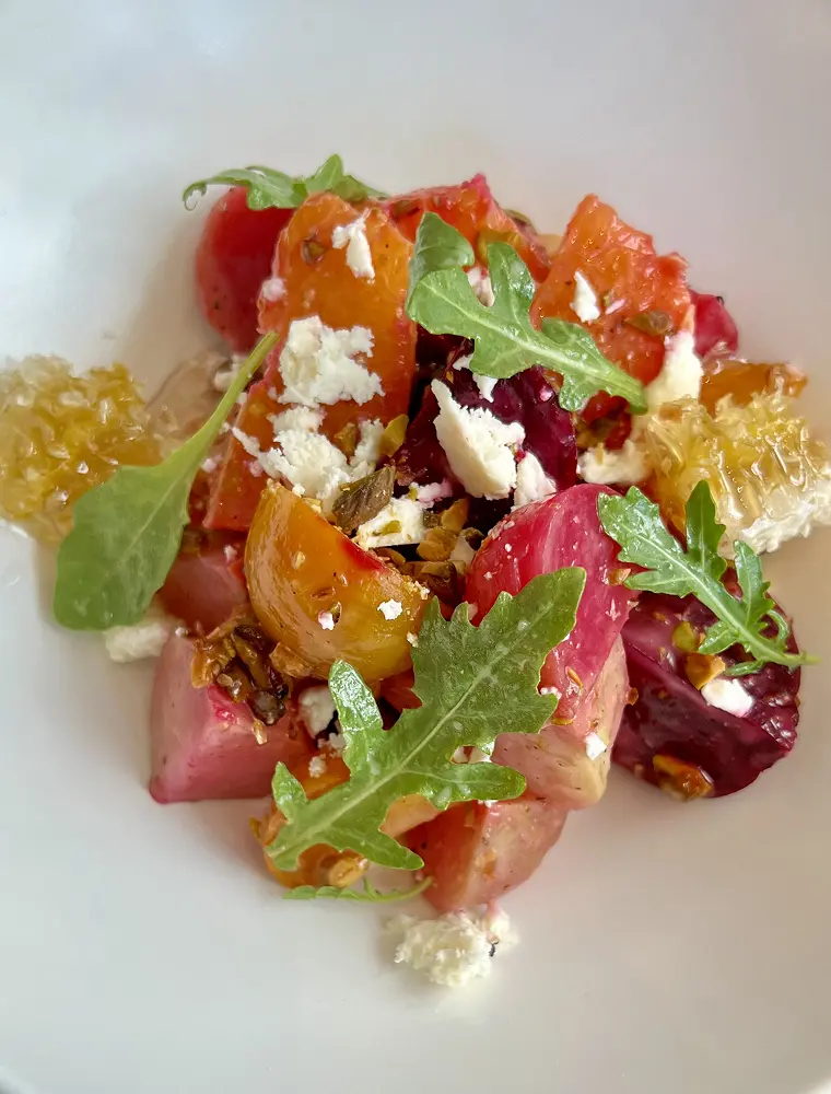 Fresh beetroot salad garnished with arugula