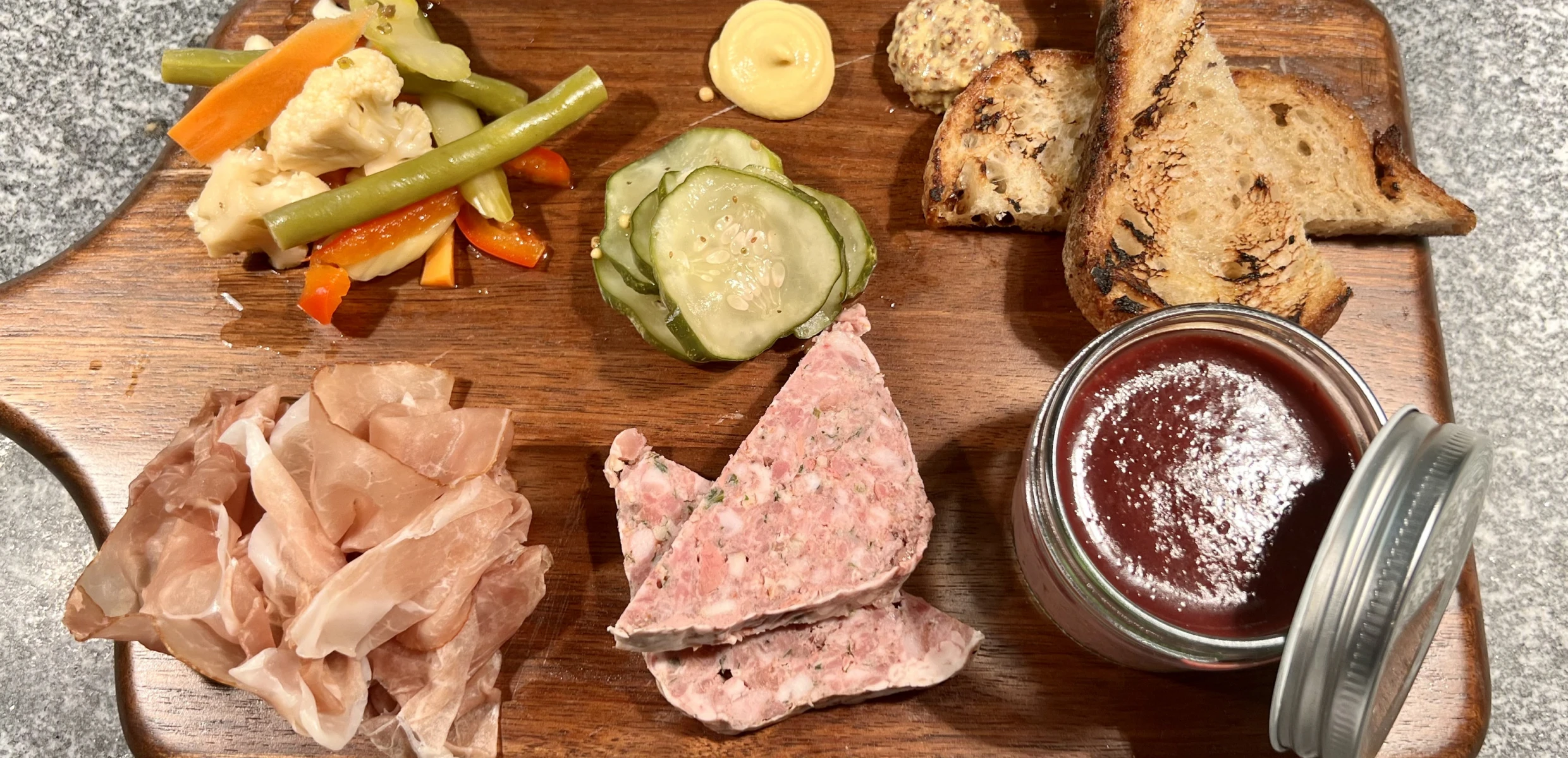 Charcuterie board with meats and pickles