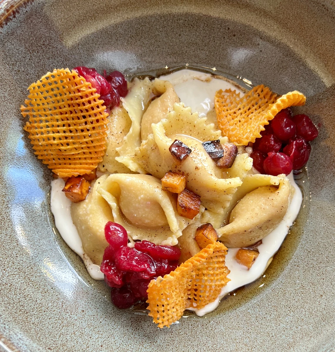 Gourmet pasta with creamy sauce and garnishes