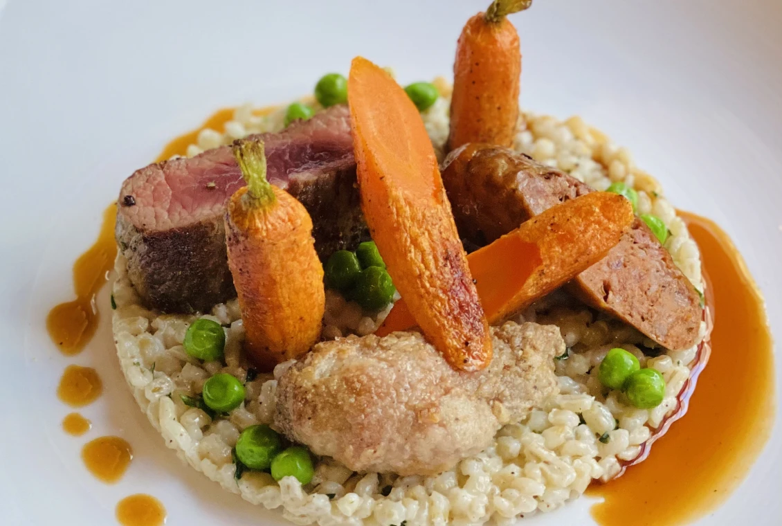 Elegant plated meal with carrots and peas