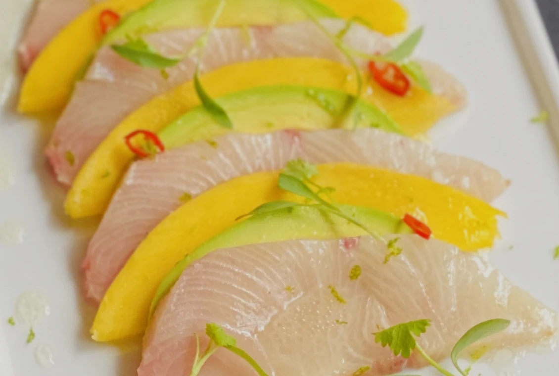 Fresh sashimi garnished with mango and chili